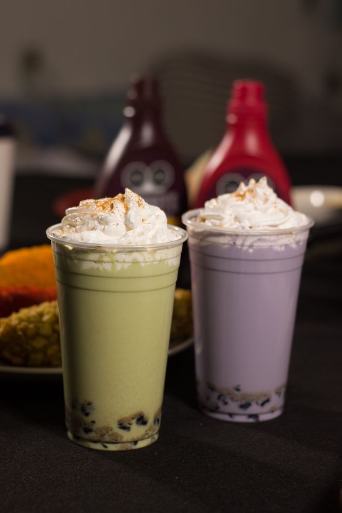 Mastering the First Impression: Your intriguing post title goes here Two colorful boba milk teas with whipped cream, featuring vibrant green and purple colors.